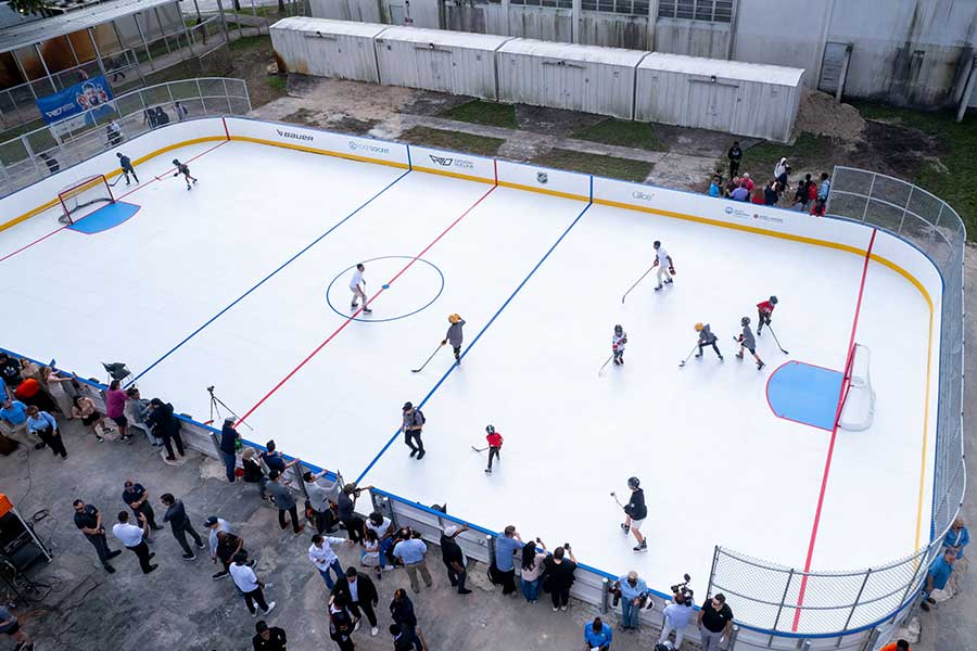 Students playing hockey on the Boyd Anderson High School synthetic ice rink