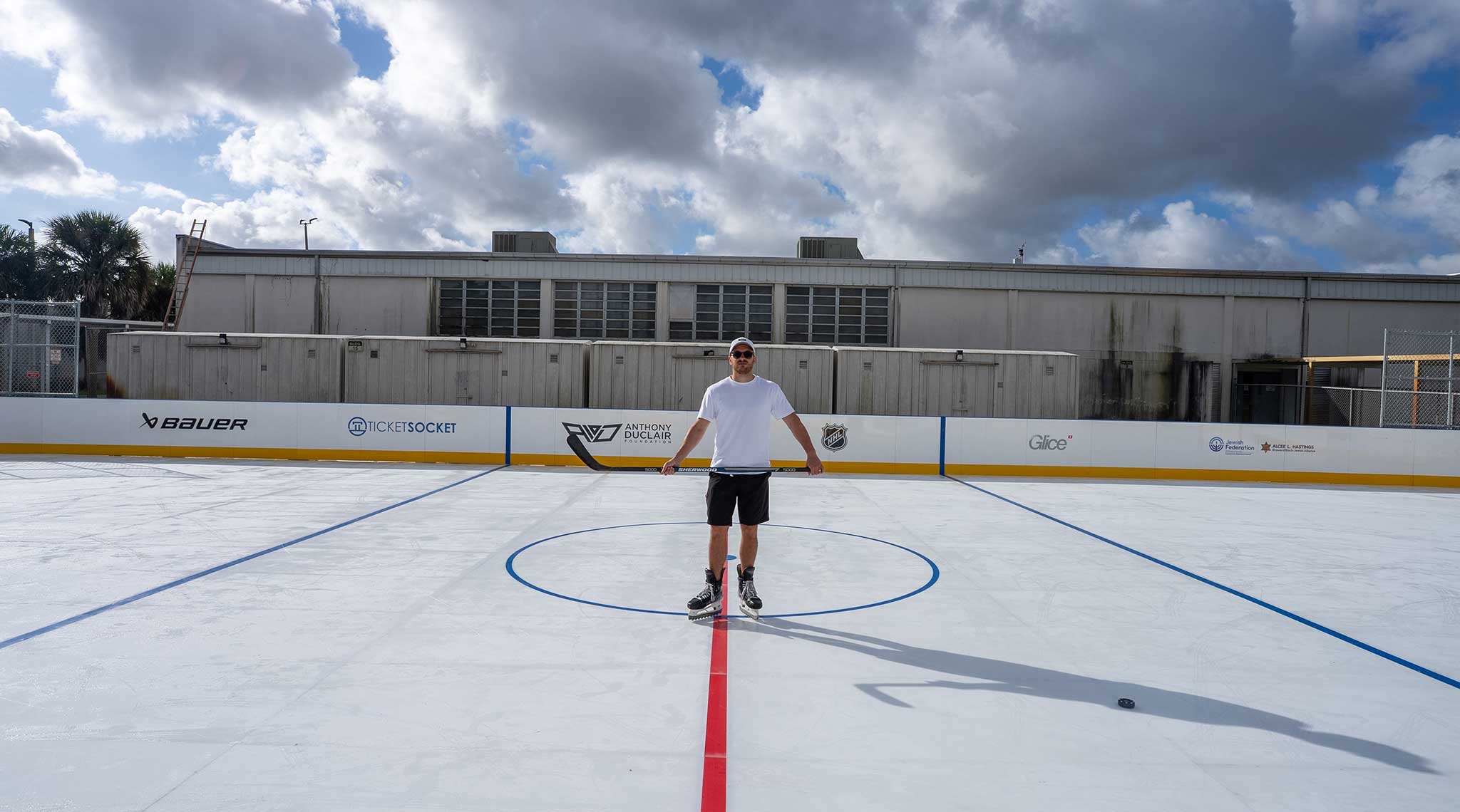 Coach leading a youth hockey clinic on synthetic ice